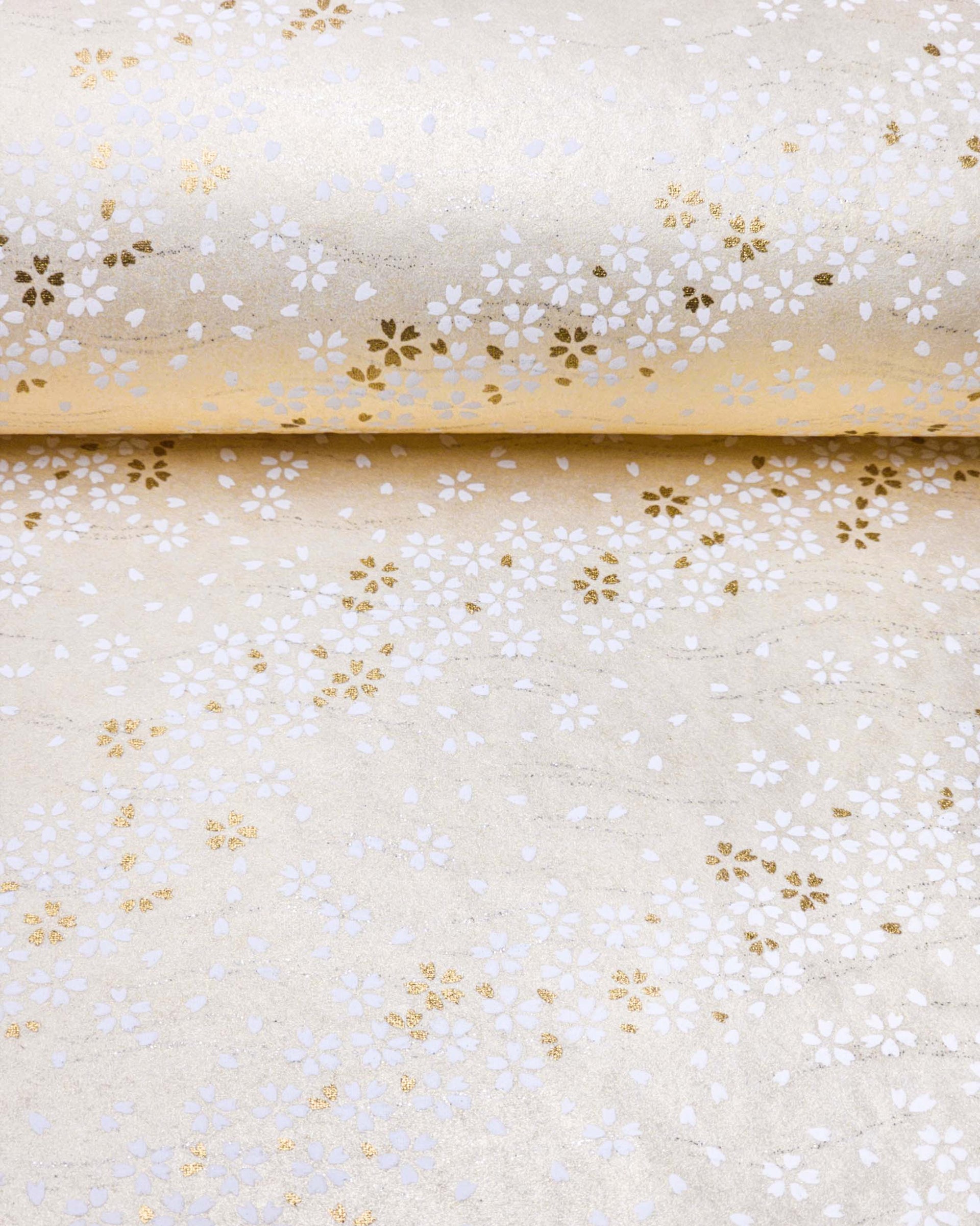 Japanese chiyogami paper featuring small white and metallic gold cherry blossoms on pearlescent cream background with metallic silver details.