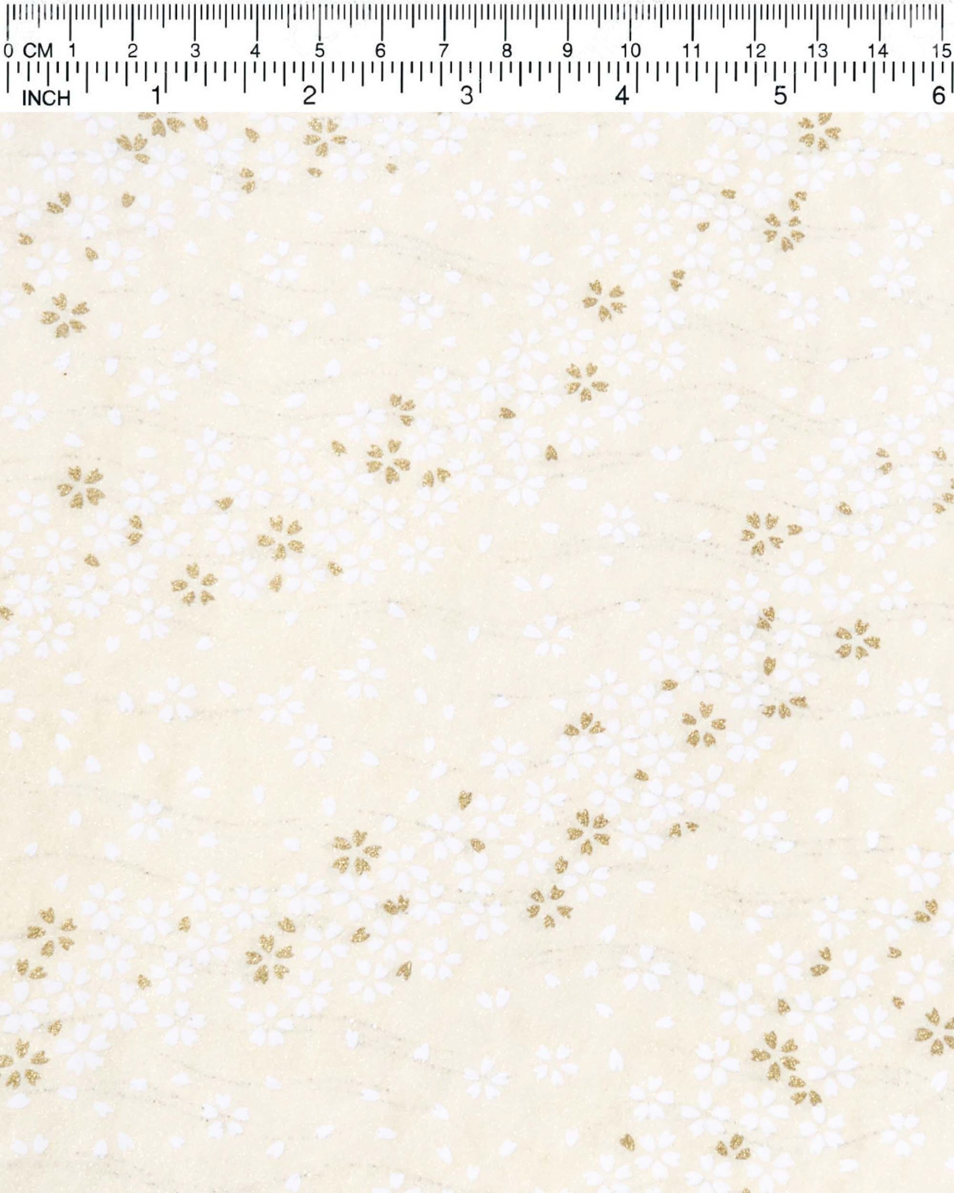 Japanese chiyogami paper featuring small white and metallic gold cherry blossoms on pearlescent cream background with metallic silver details.
