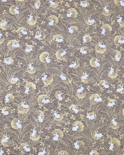 Japanese chiyogami paper featuring white rabbits with gold moons on a brown background with metallic gold details.
