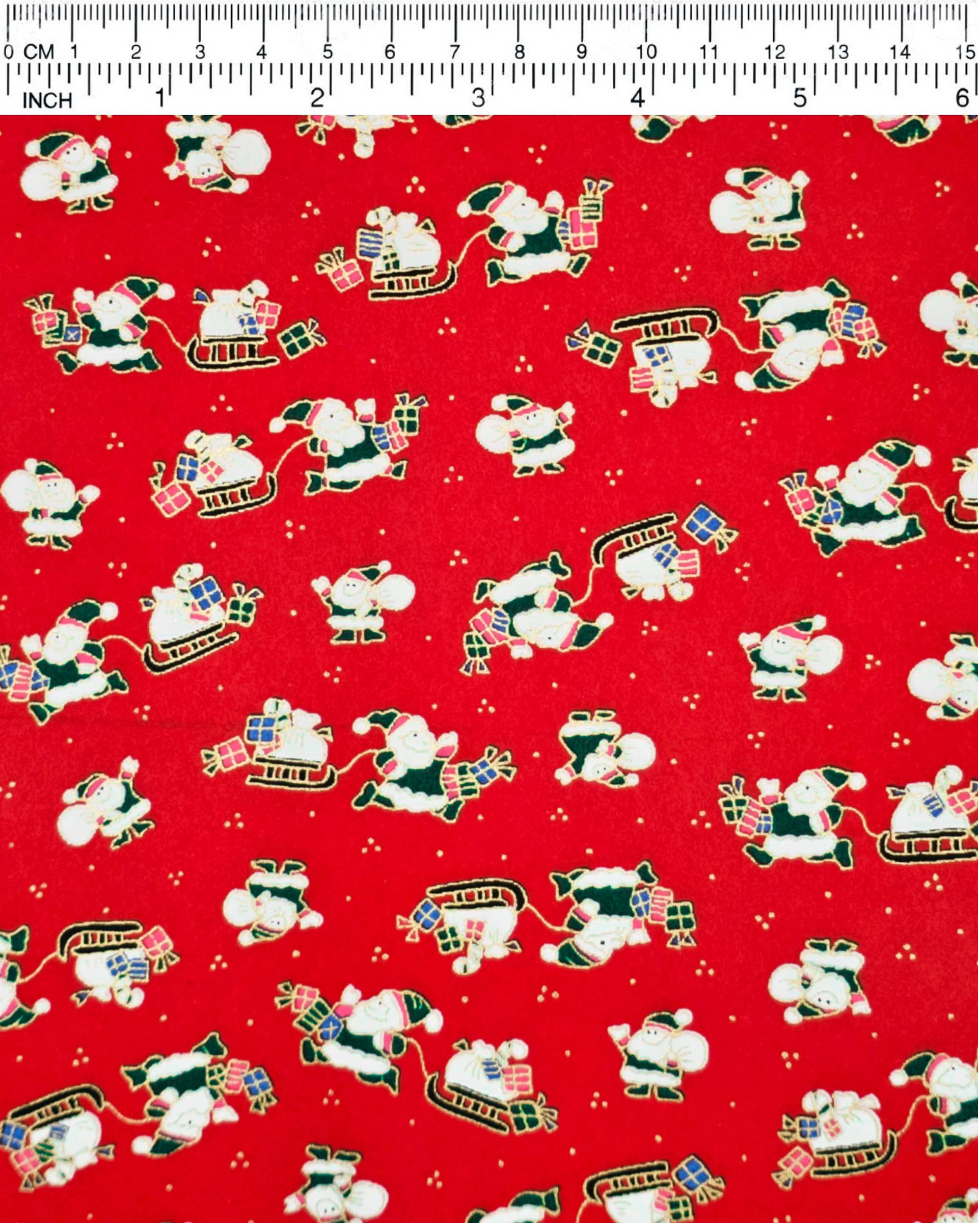 Japanese chiyogami paper featuring cartoon Santas in green outfits pulling sleds with presents and carrying sacks of presents on a red background with metallic gold details. 
