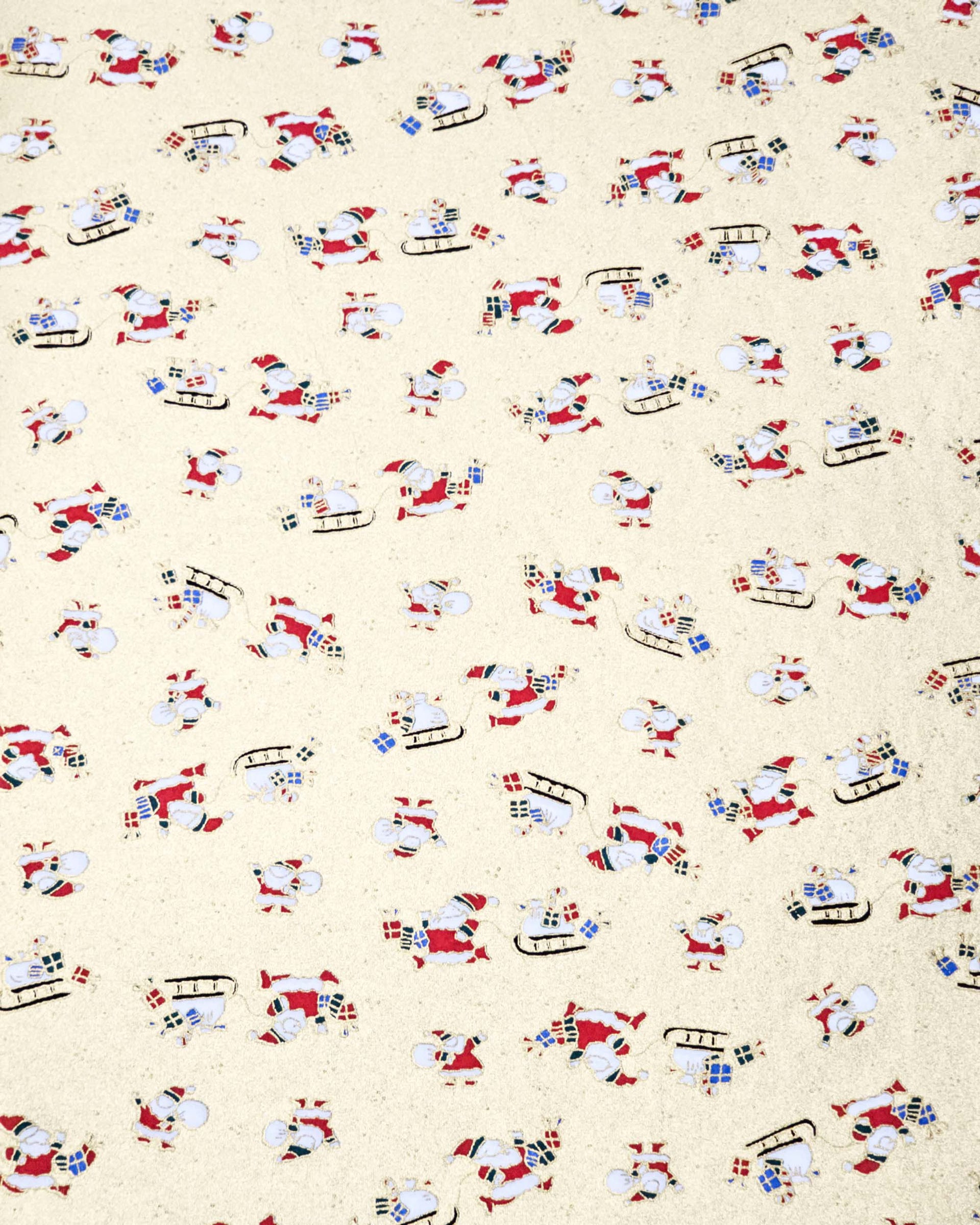 Japanese chiyogami paper featuring Santa and his sleigh on a metallic gold background.