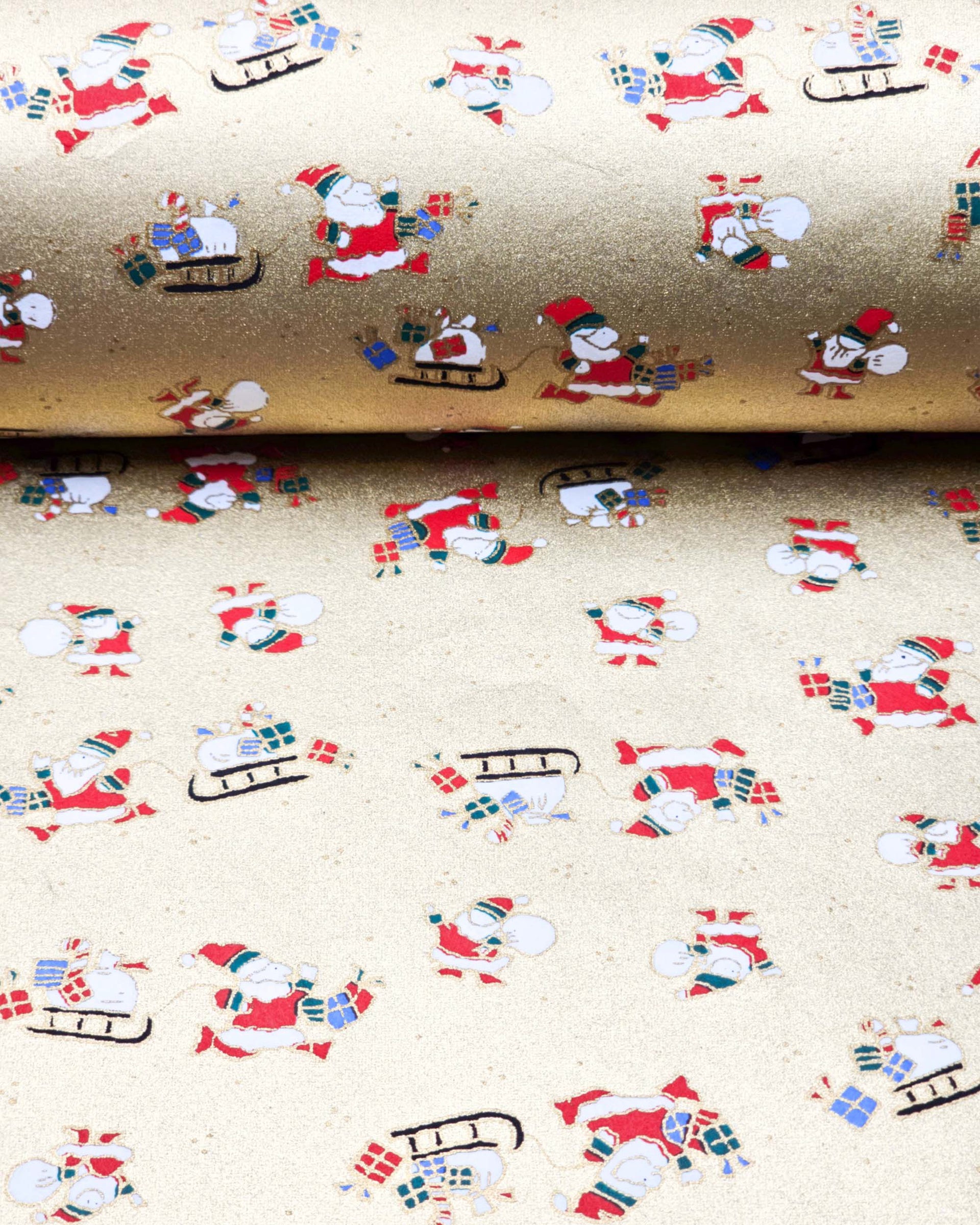 Japanese chiyogami paper featuring Santa and his sleigh on a metallic gold background.