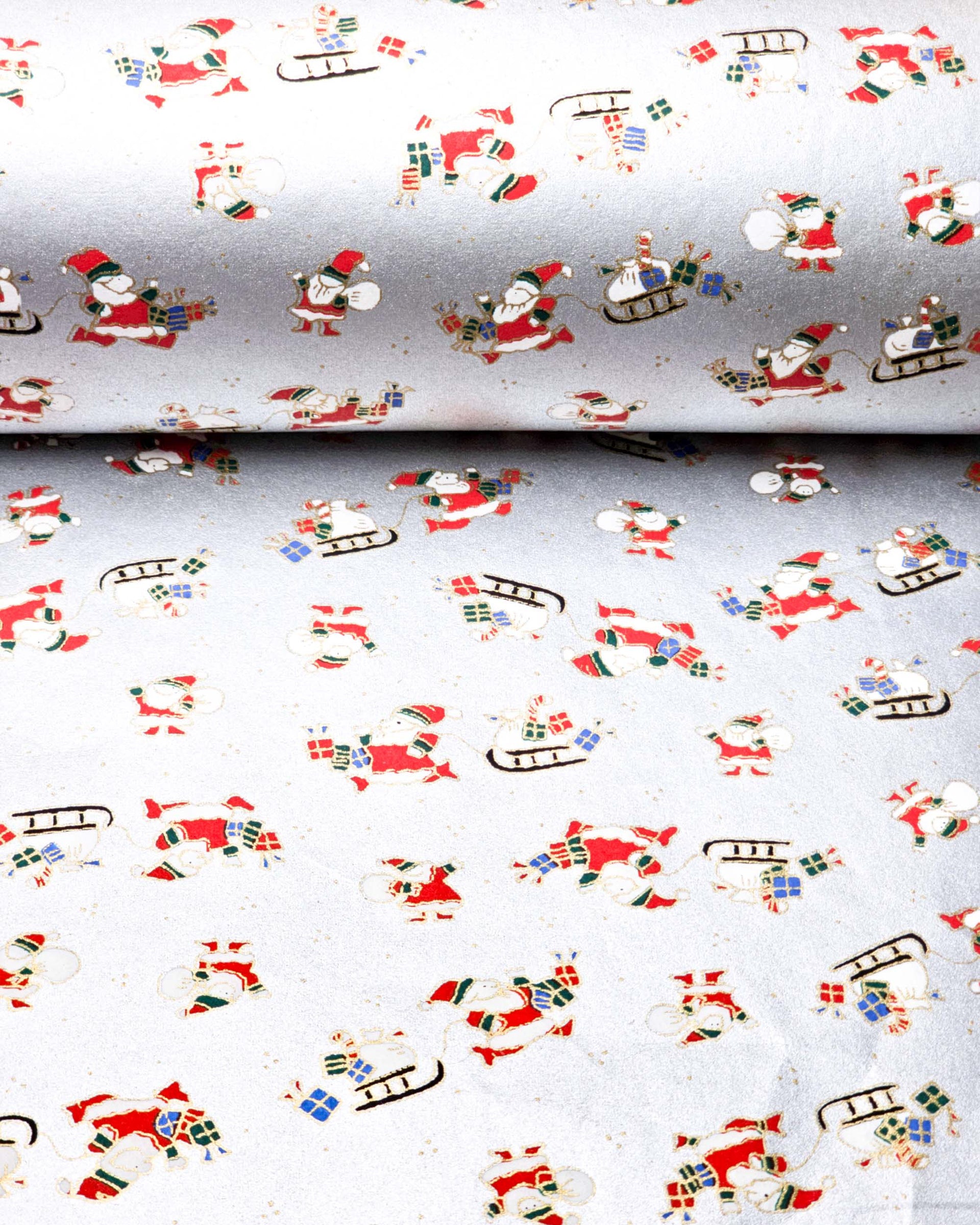 Japanese chiyogami paper featuring Santa and his sleigh on a metallic silver background.