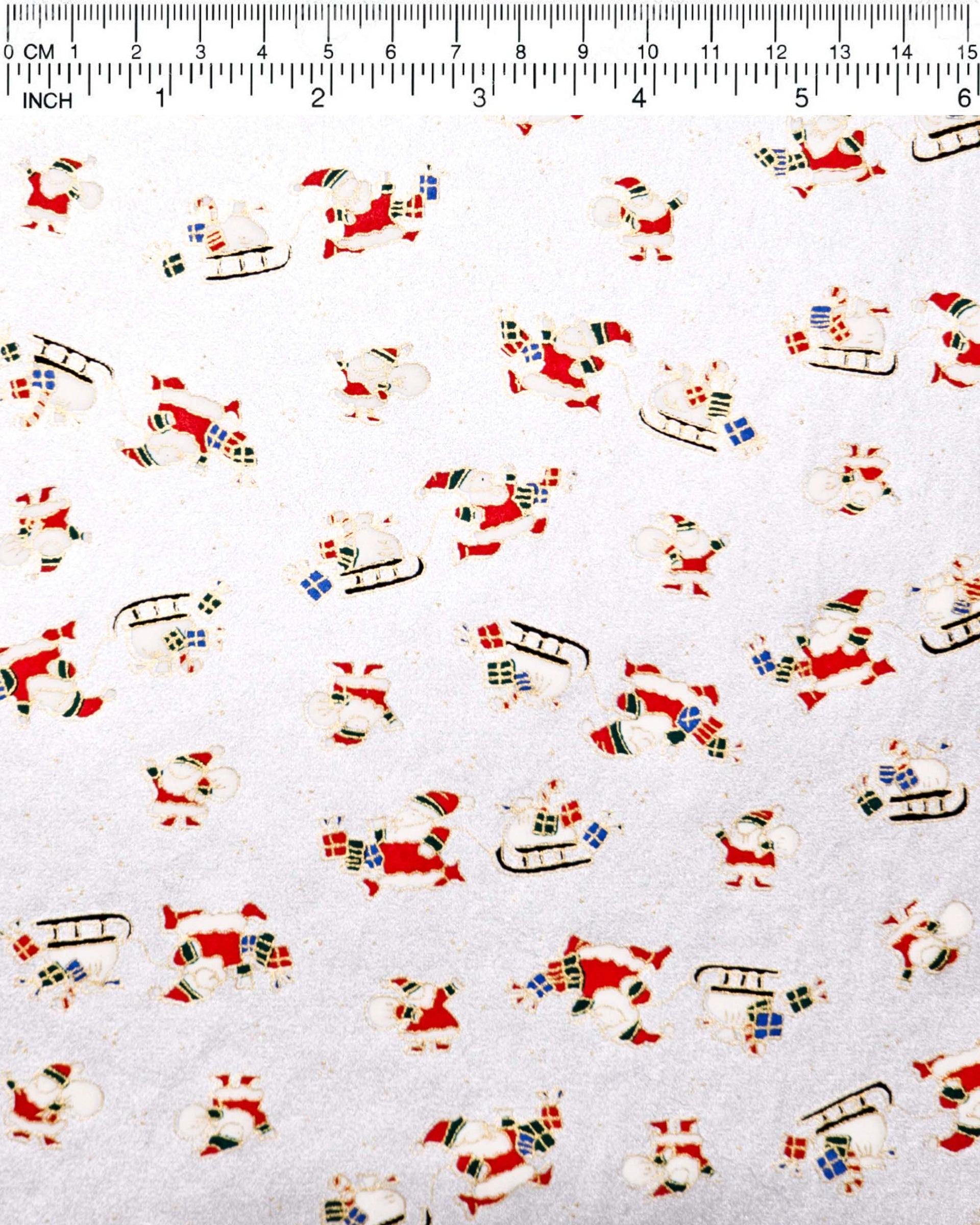 Japanese chiyogami paper featuring Santa and his sleigh on a metallic silver background.