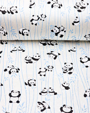 Japanese chiyogami paper featuring black and white pandas with blue bamboo stalks on a pearlescent white background.