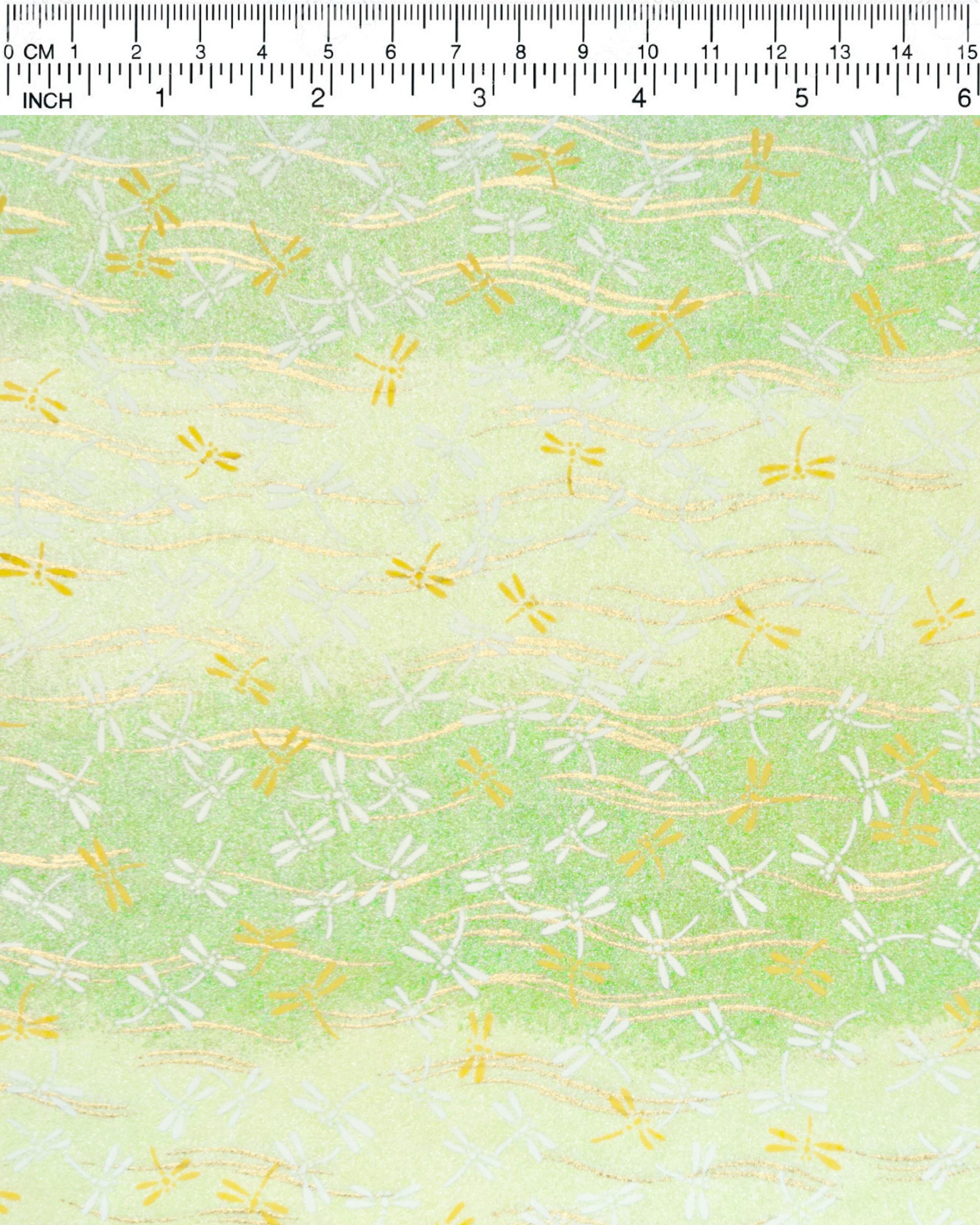 Japanese chiyogami paper featuring yellow and white dragonflies on a pearlescent green gradient background with metallic gold wavy lines.