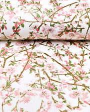 Japanese chiyogami paper featuring pink and white detailed plum blossoms with brown branches and green leaves on a white background with metallic gold details.
