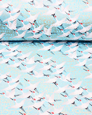 Japanese chiyogami paper featuring white flying cranes and gold kanzemizu (swirling water) on an aqua blue background with metallic gold details.