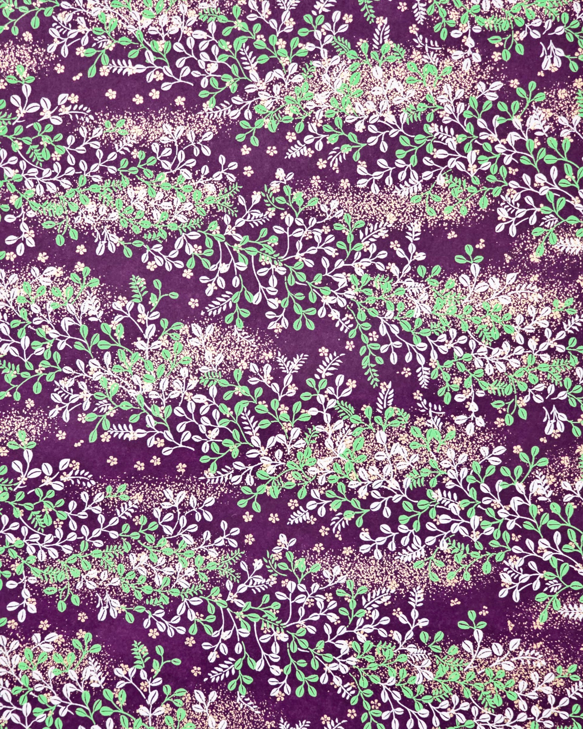 Japanese chiyogami paper featuring green and white hagi (bush clover) on a purple background with metallic gold details.