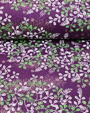 Japanese chiyogami paper featuring green and white hagi (bush clover) on a purple background with metallic gold details.