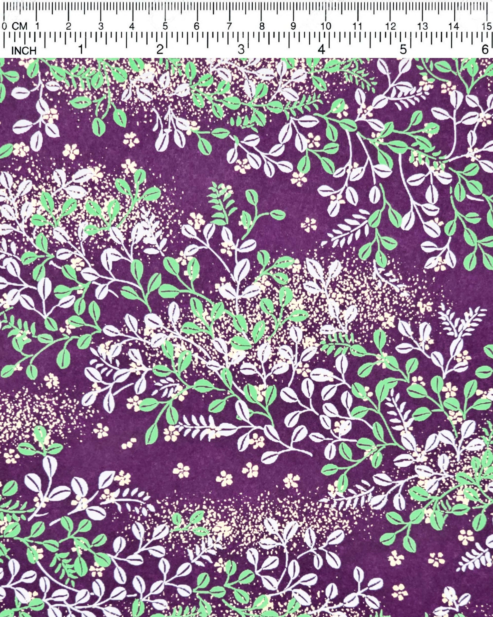Japanese chiyogami paper featuring green and white hagi (bush clover) on a purple background with metallic gold details.