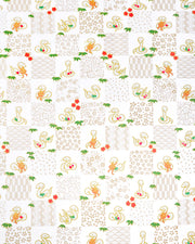 Japanese chiyogami paper featuring silver snakes and gold assorted traditional Japanese designs in an ichimatsu (checker) design on a white background with metallic gold details. Small red plum blossoms and green bamboo leaves are scattered throughout the design.