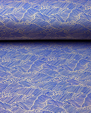 Japanese chiyogami paper featuring small metallic gold waves (aranami) on a dark blue background.
