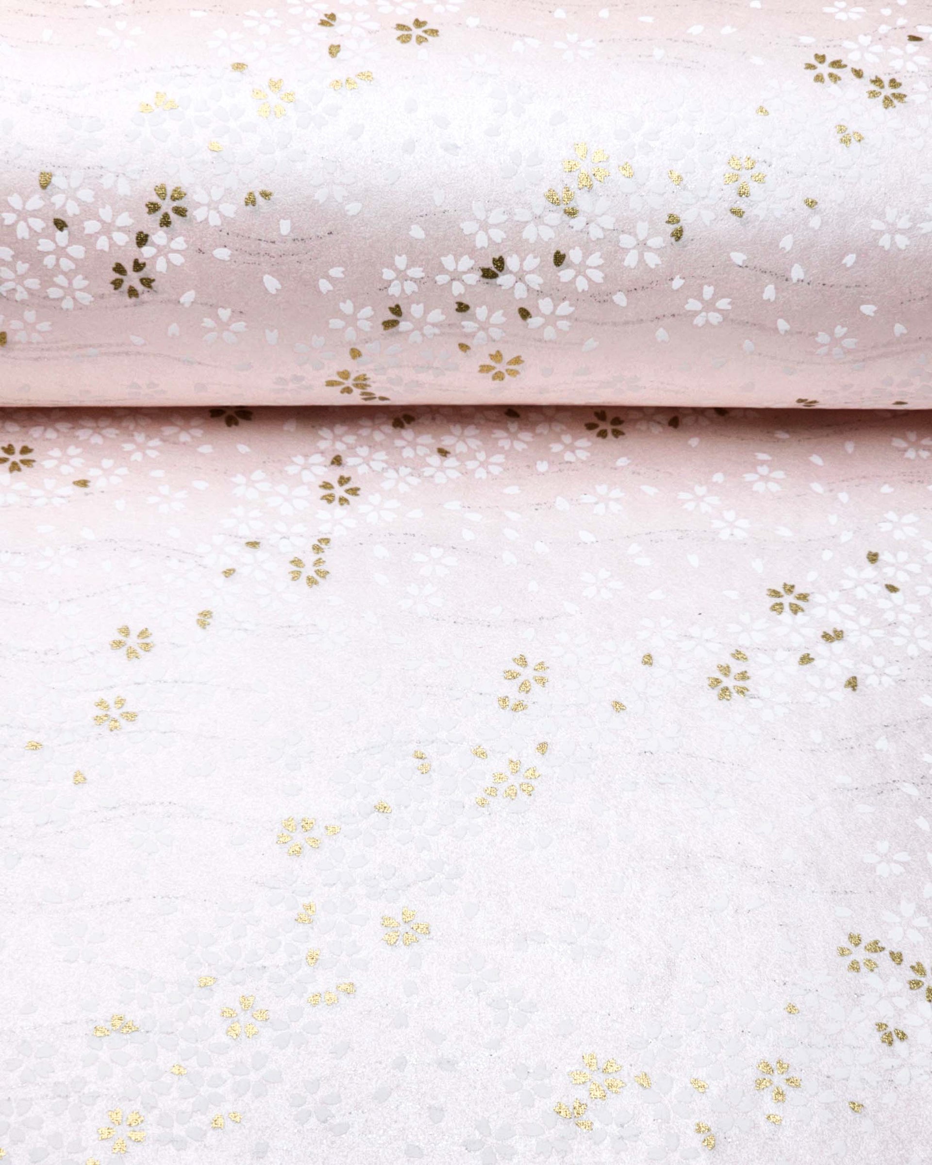Japanese chiyogami paper featuring small white and metallic gold cherry blossoms on pearlescent pink background with metallic silver details.