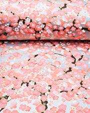 Japanese chiyogami paper featuring pink and white plum blossom trees with dark brown branches on a silver background with metallic gold details.