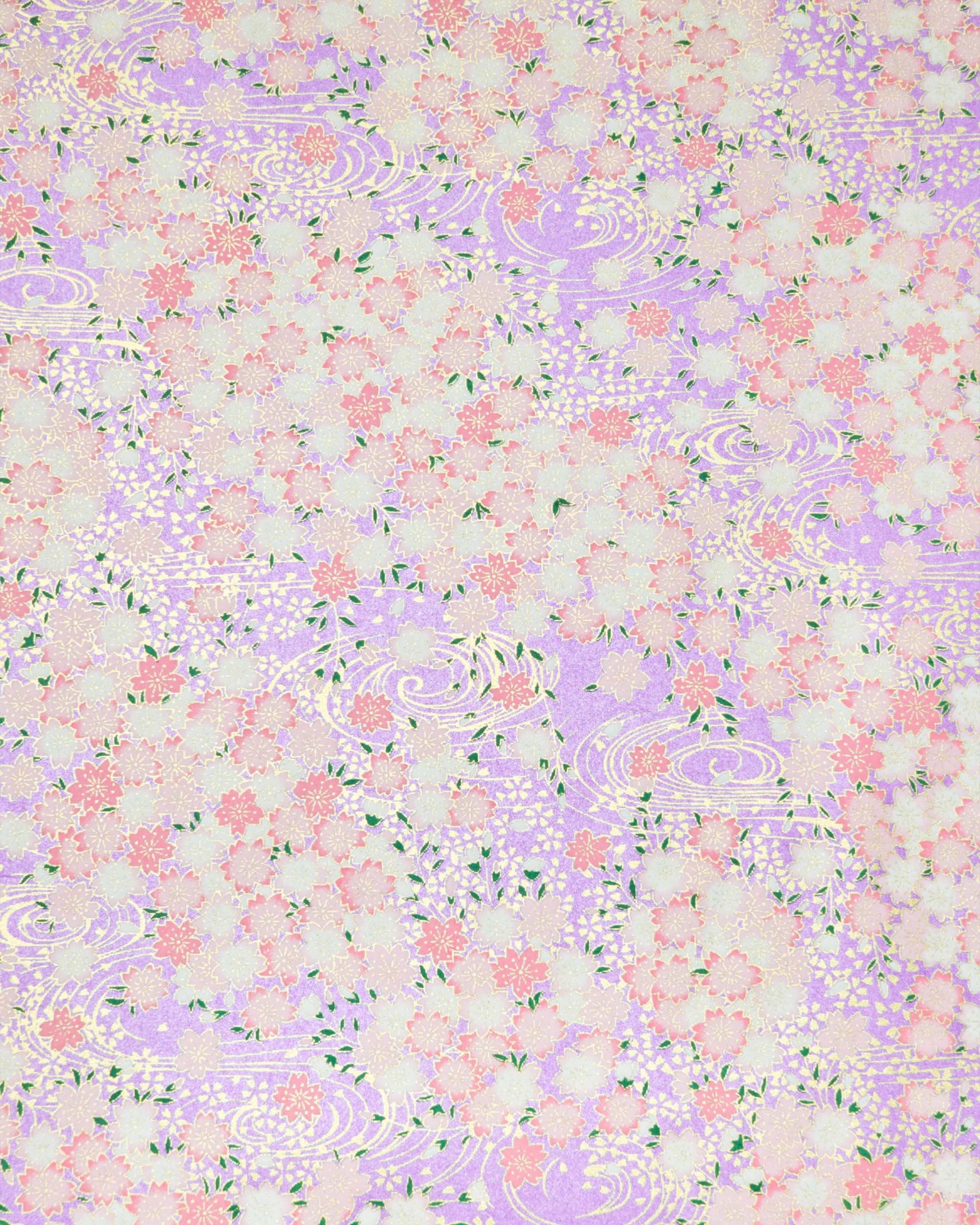 Japanese chiyogami paper featuring pink and white cherry blossoms on a pearlescent light purple background with metallic gold details.