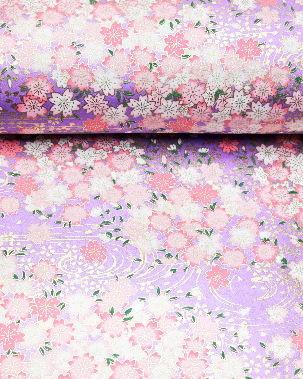 Japanese chiyogami paper featuring pink and white cherry blossoms on a pearlescent light purple background with metallic gold details.