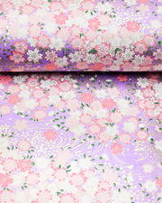 Japanese chiyogami paper featuring pink and white cherry blossoms on a pearlescent light purple background with metallic gold details.