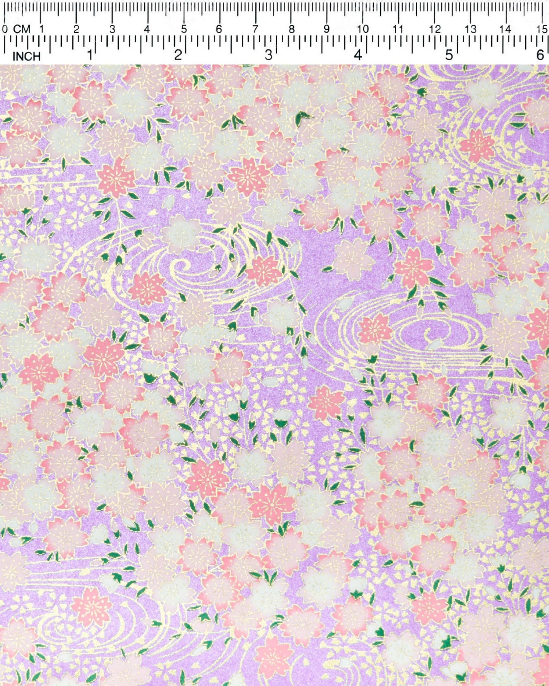Japanese chiyogami paper featuring pink and white cherry blossoms on a pearlescent light purple background with metallic gold details.