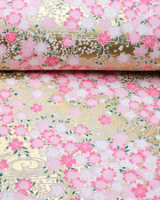 Japanese chiyogami paper featuring pink and white cherry blossoms on a metallic gold background.