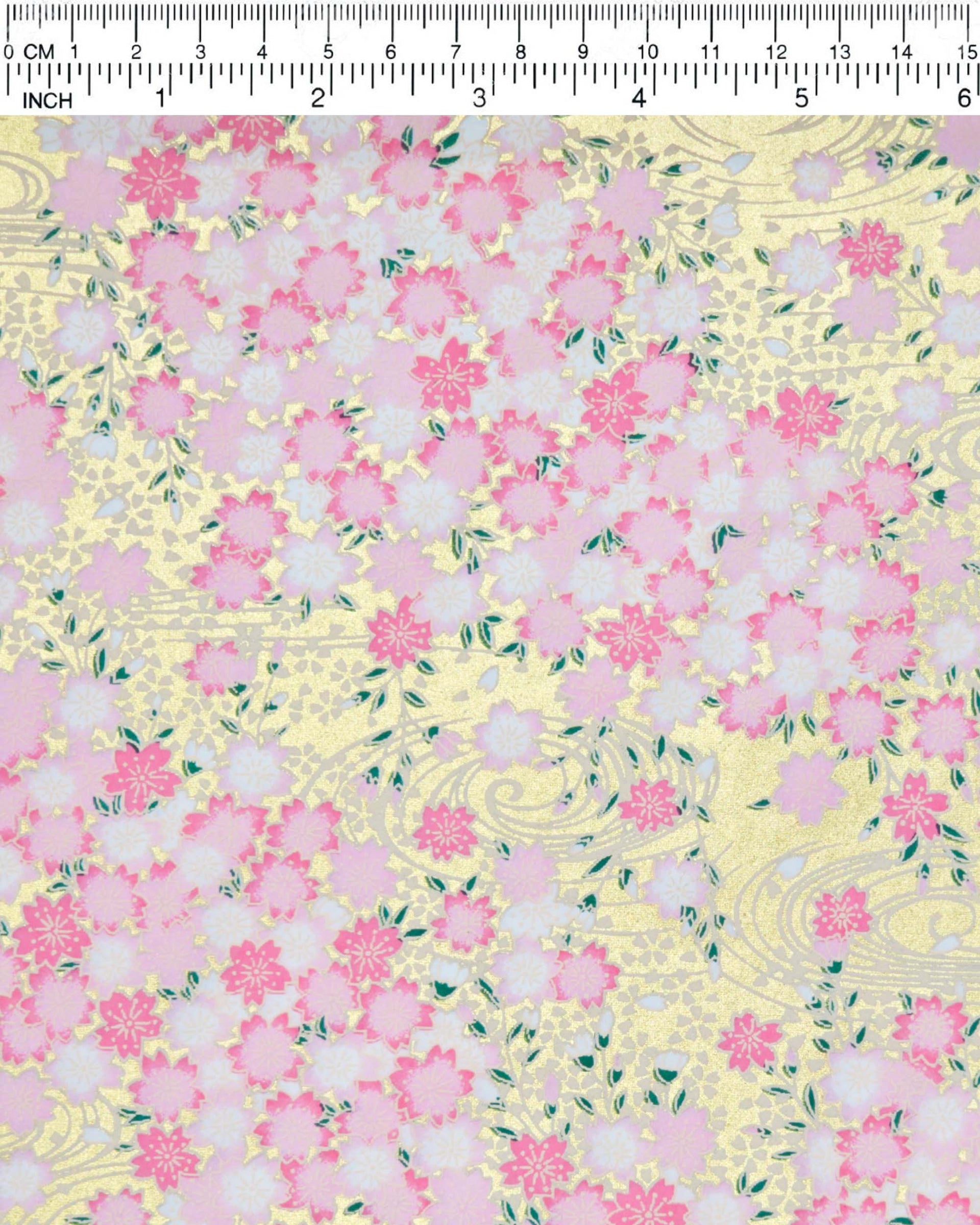Japanese chiyogami paper featuring pink and white cherry blossoms on a metallic gold background.
