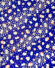 Japanese chiyogami paper featuring white and red Maneki Neko (lucky cats) with small white and gold cherry blossoms and temari balls on a dark blue background with metallic gold details.