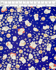Japanese chiyogami paper featuring white and red Maneki Neko (lucky cats) with small white and gold cherry blossoms and temari balls on a dark blue background with metallic gold details.