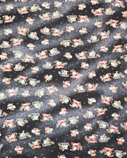 Japanese chiyogami paper featuring Santa and his sleigh on a black and background with metallic gold accents and metallic silver glitter.
