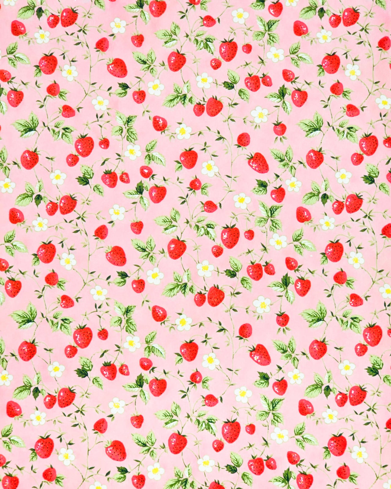 Japanese chiyogami paper featuring red strawberries with green leaves and white flowers with yellow centers on a pink background. 