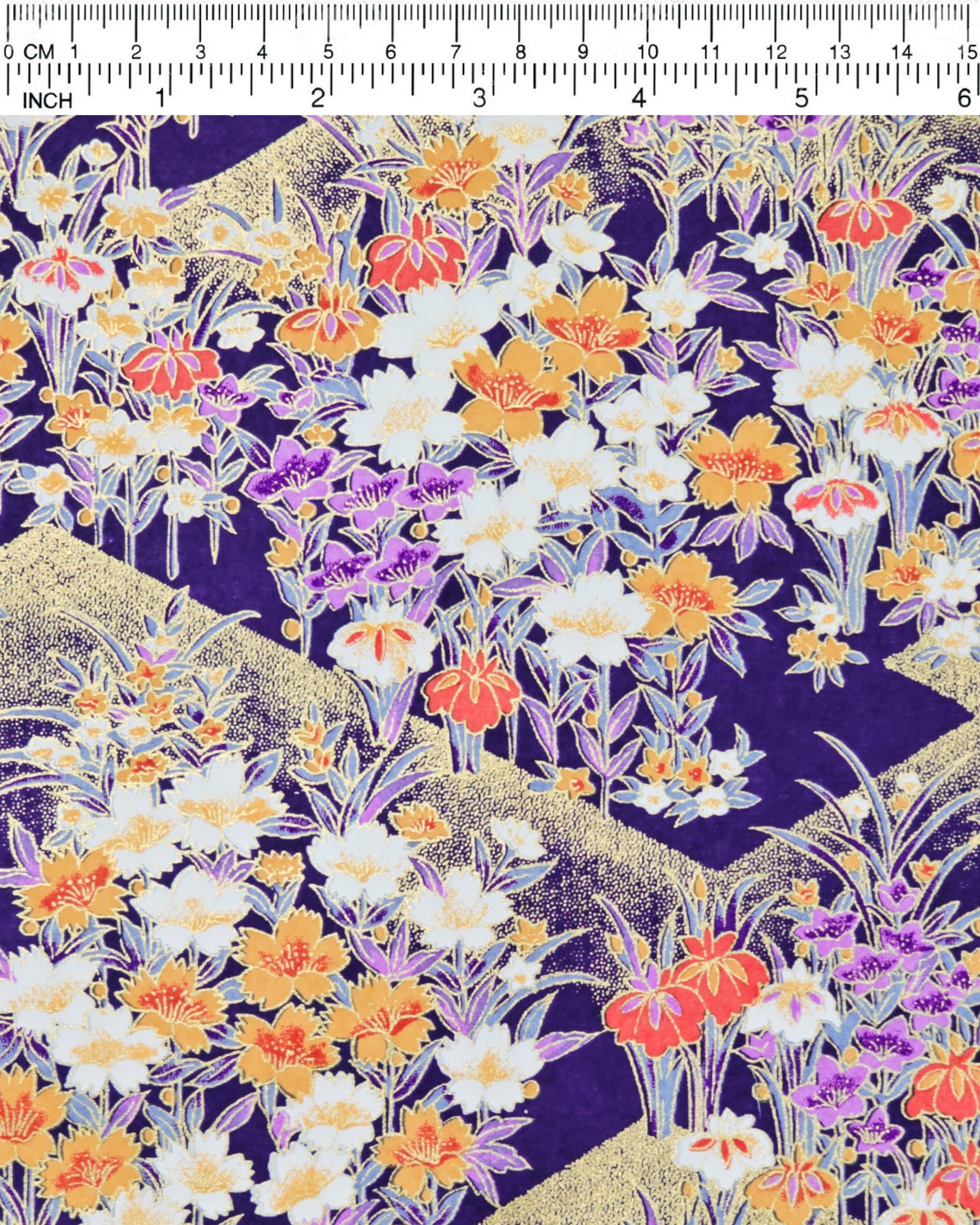 Japanese chiyogami paper featuring orange, purple, and white irises with green stems on a dark blue background with metallic gold details.