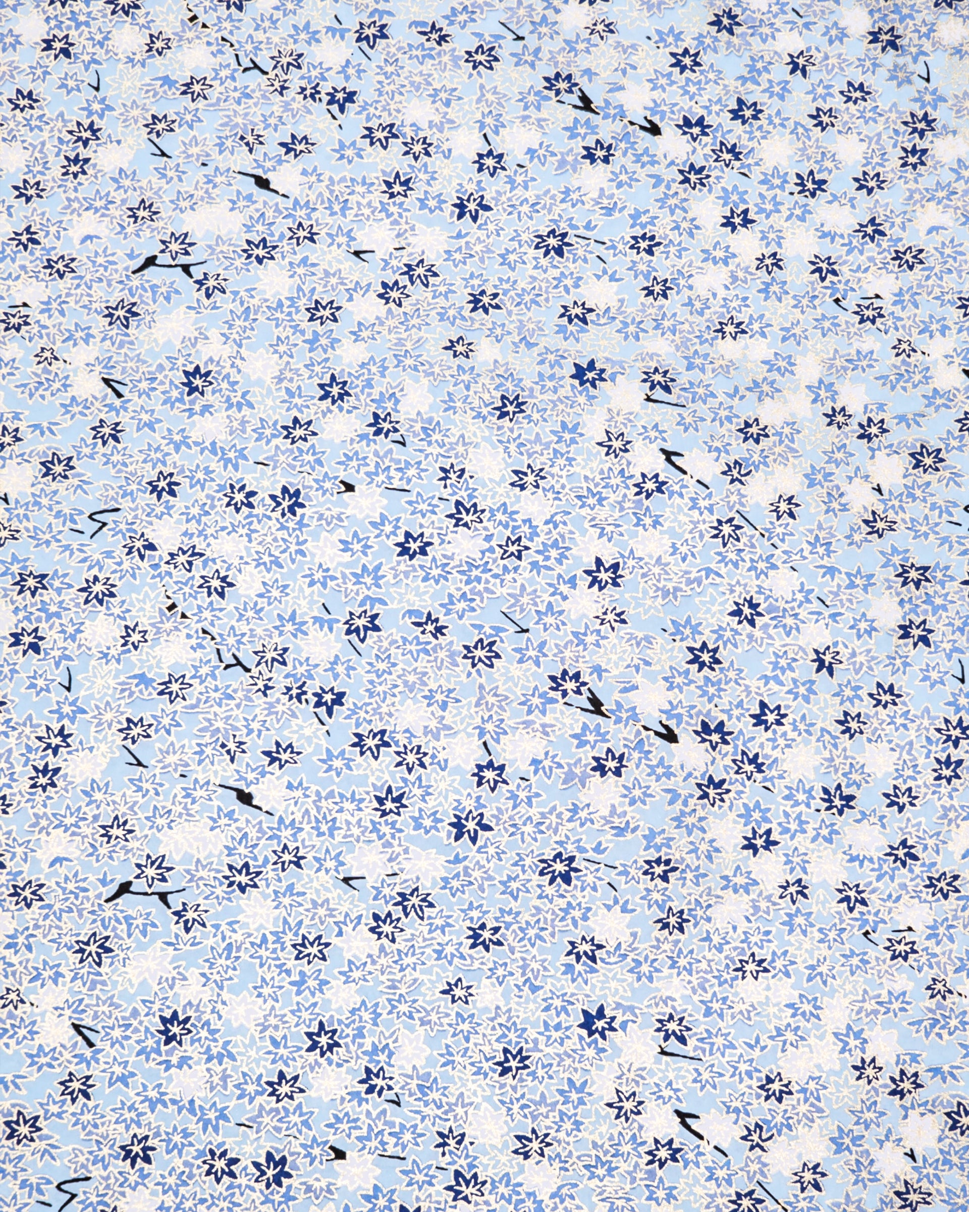 Japanese chiyogami paper featuring small blue and white momiji (maple leaves) on a light blue background with metallic gold details.