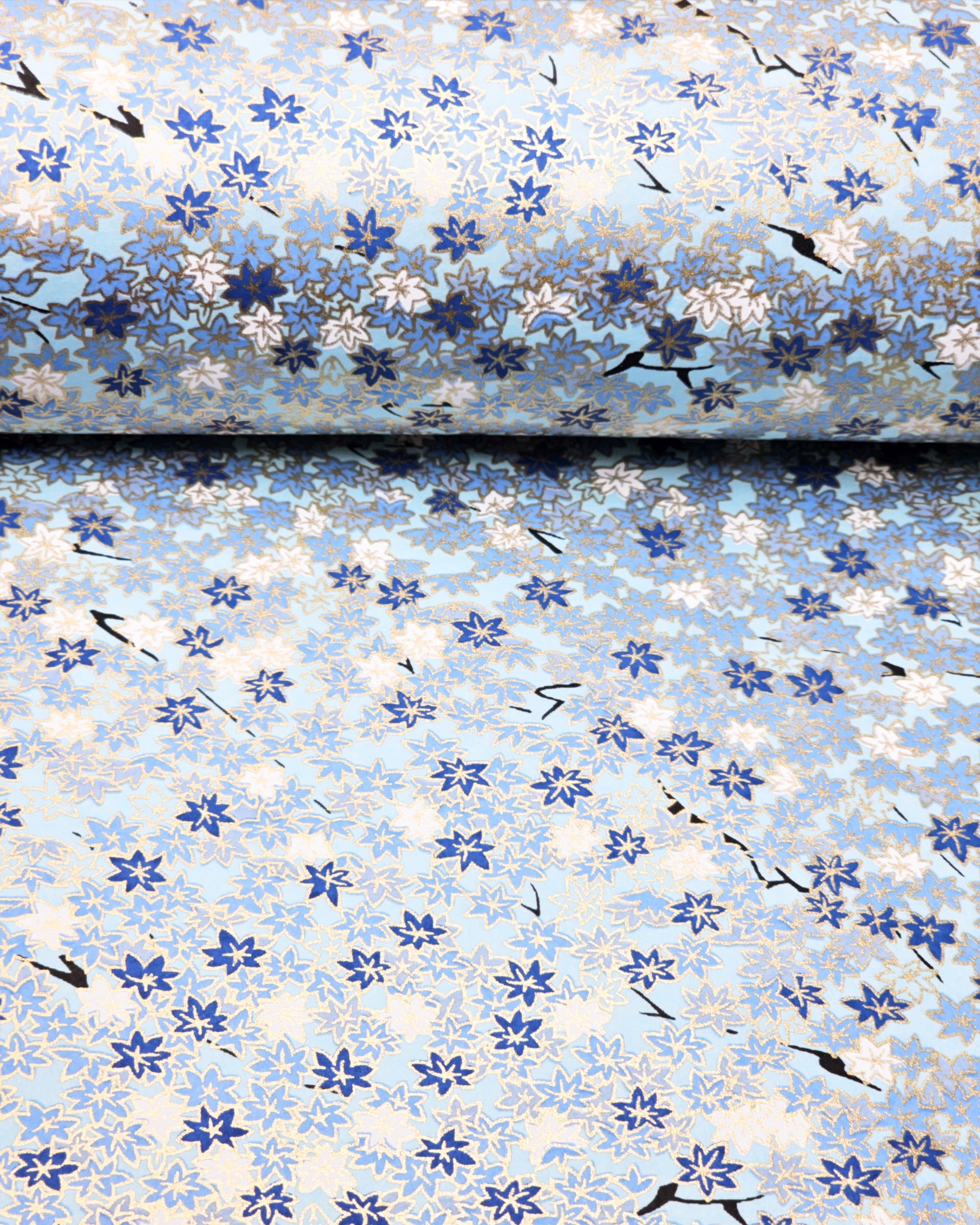 Japanese chiyogami paper featuring small blue and white momiji (maple leaves) on a light blue background with metallic gold details.