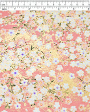 Japanese chiyogami paper featuring light pink and white cherry blossoms on a pink background with metallic gold details. Some of the white cherry blossoms have purple centers.