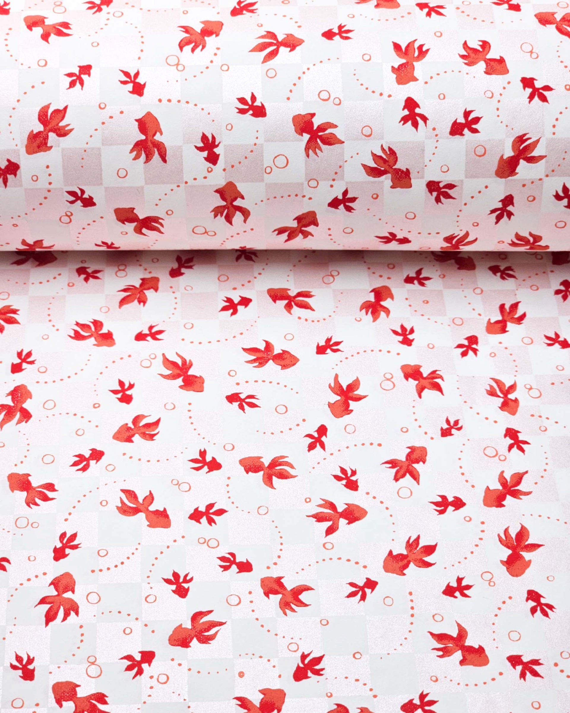 Japanese chiyogami paper featuring red koi fishes on a white and light pearlescent pink ichimatsu (checker) background.