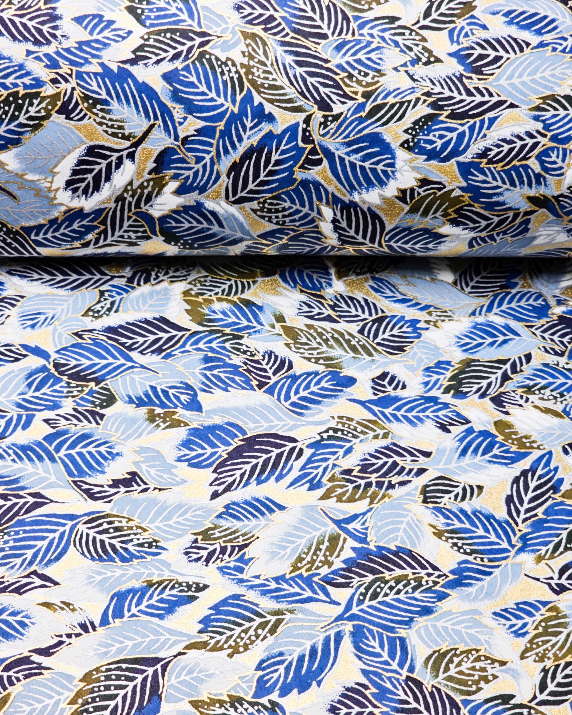 Japanese chiyogami paper featuring blue leaves on a metallic gold background.