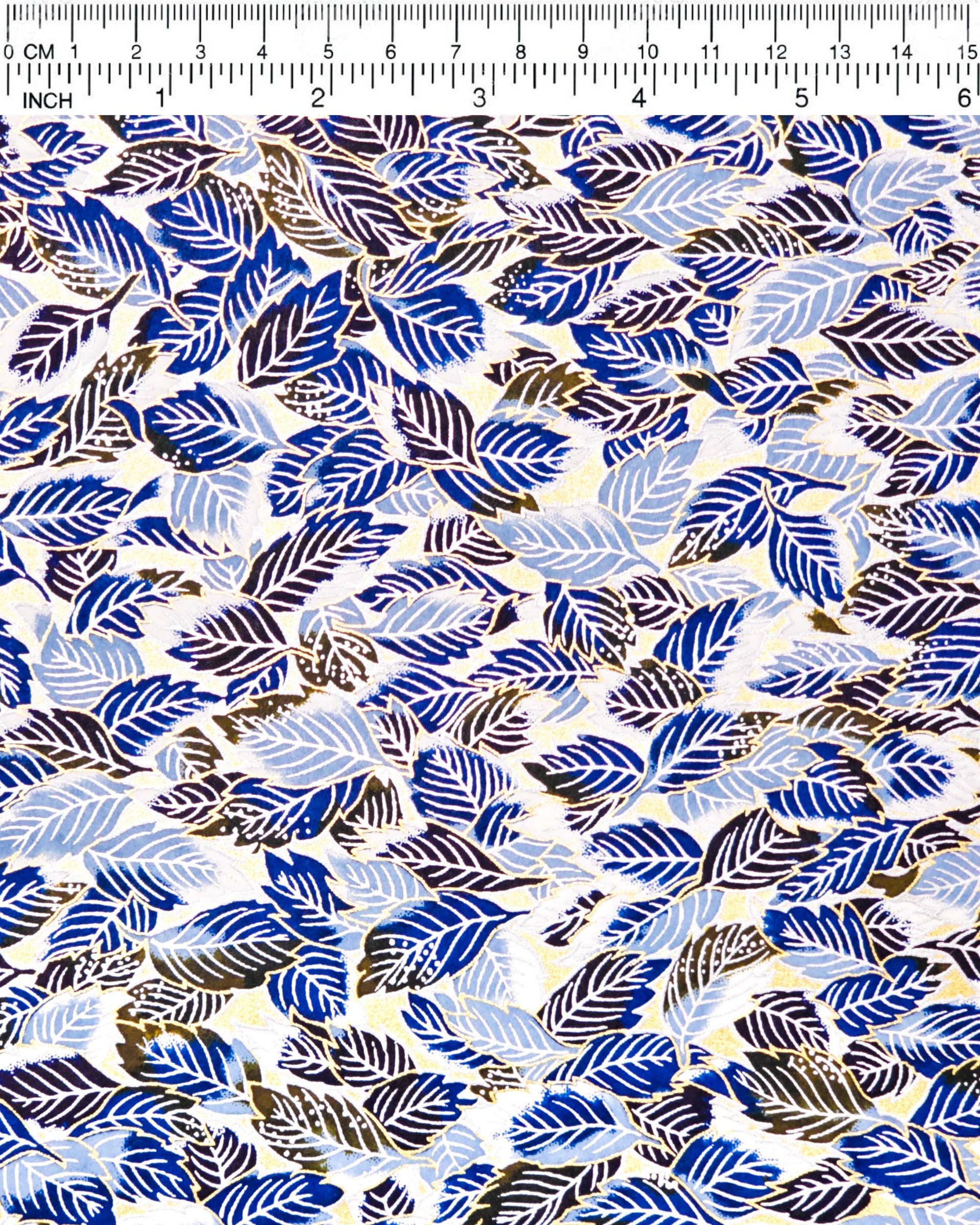 Japanese chiyogami paper featuring blue leaves on a metallic gold background.