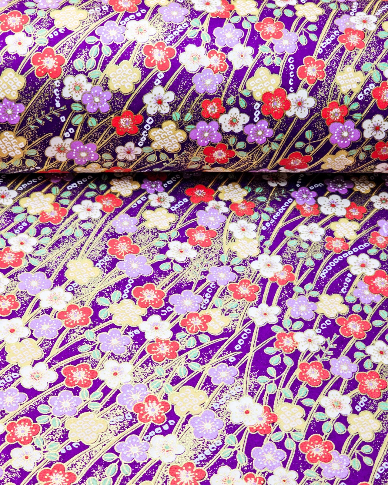 This design features purple, red, white, and yellow plum blossoms on a purple background with metallic gold accents.