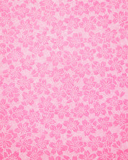 Japanese chiyogami paper featuring a pointillistic cherry blossom design on a pink background.