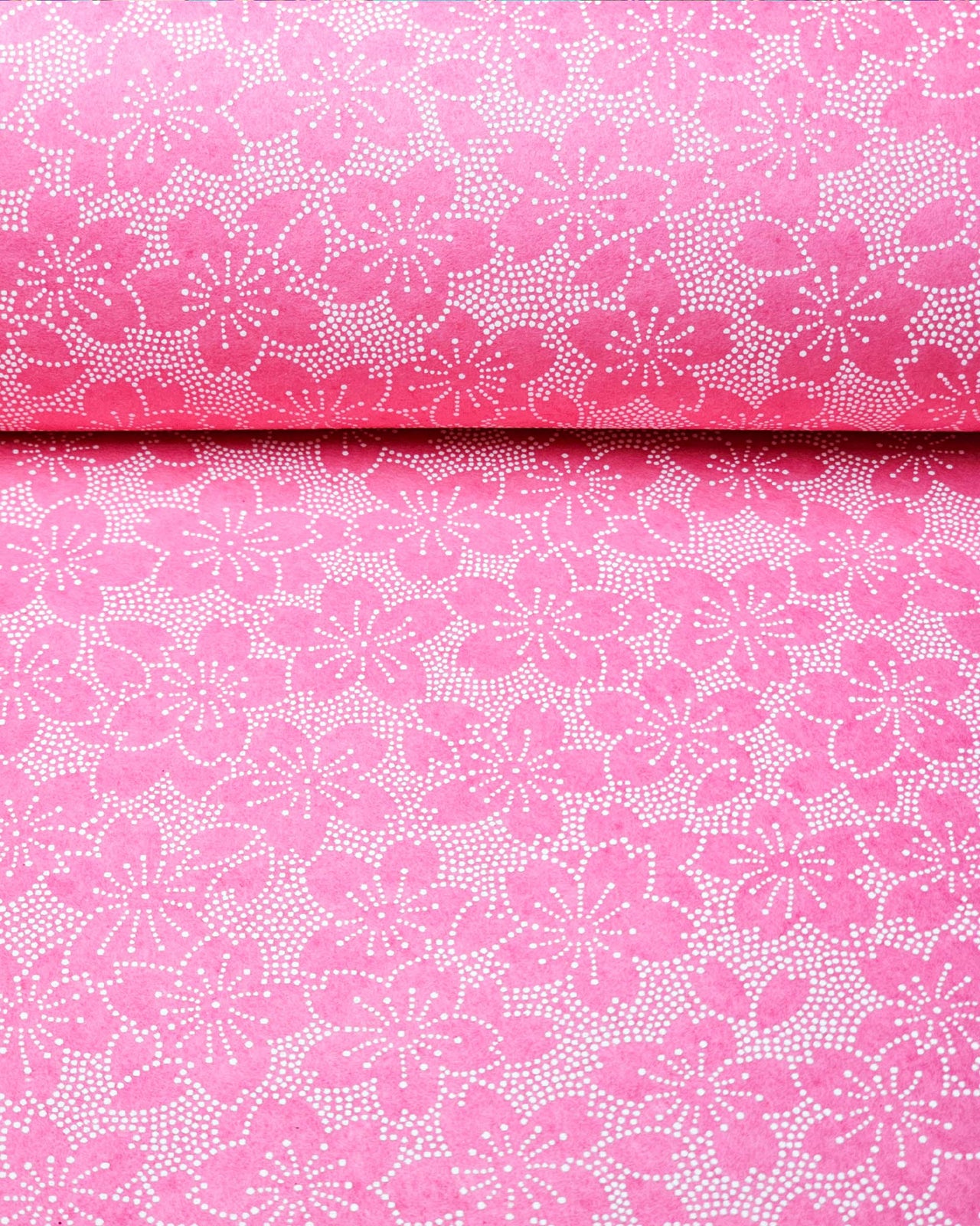 Japanese chiyogami paper featuring a pointillistic cherry blossom design on a pink background.