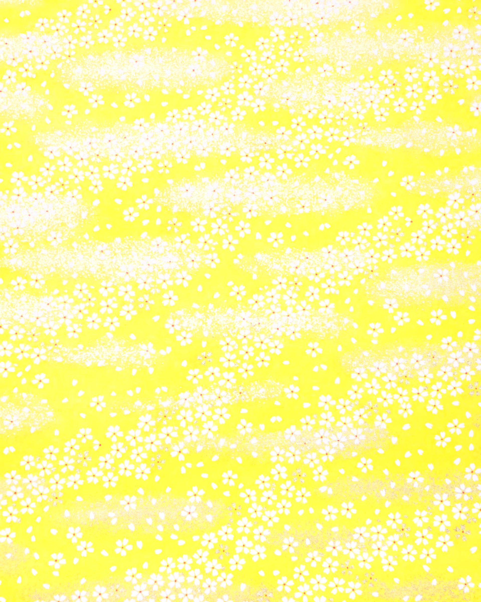 Japanese chiyogami paper featuring small metallic gold and white cherry blossoms on a yellow background.