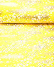Japanese chiyogami paper featuring small metallic gold and white cherry blossoms on a yellow background.