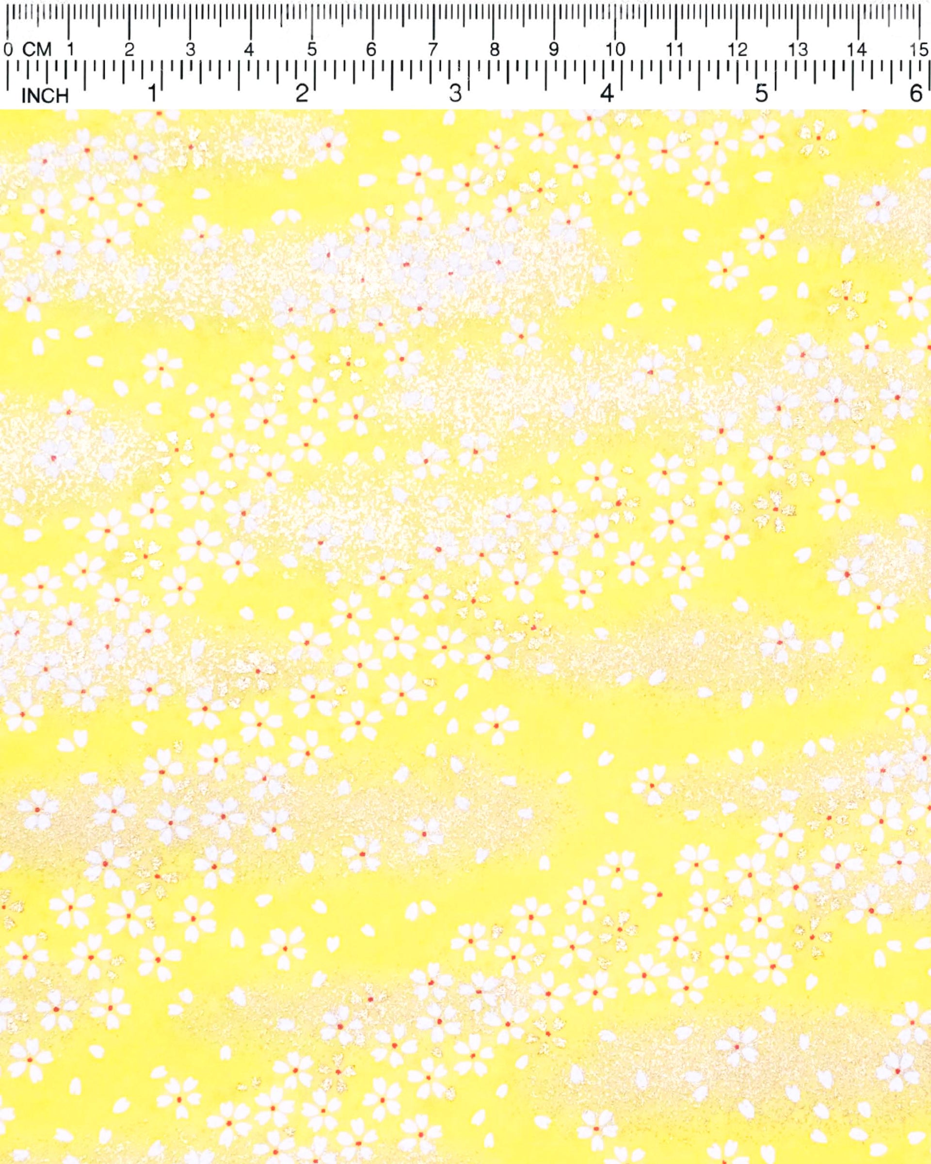 Japanese chiyogami paper featuring small metallic gold and white cherry blossoms on a yellow background.