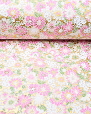 Japanese chiyogami paper featuring textured white and pink mum flowers on a metallic gold background. The lines on the flowers are raised.