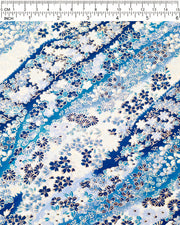 Japanese chiyogami paper featuring an assortment of blue and white traditional Japanese flowers and leaves on a blue and white gradient background with metallic gold details.