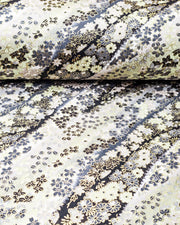 Japanese chiyogami paper featuring assorted gray and cream flowers on a gray and black background with metallic gold accents.