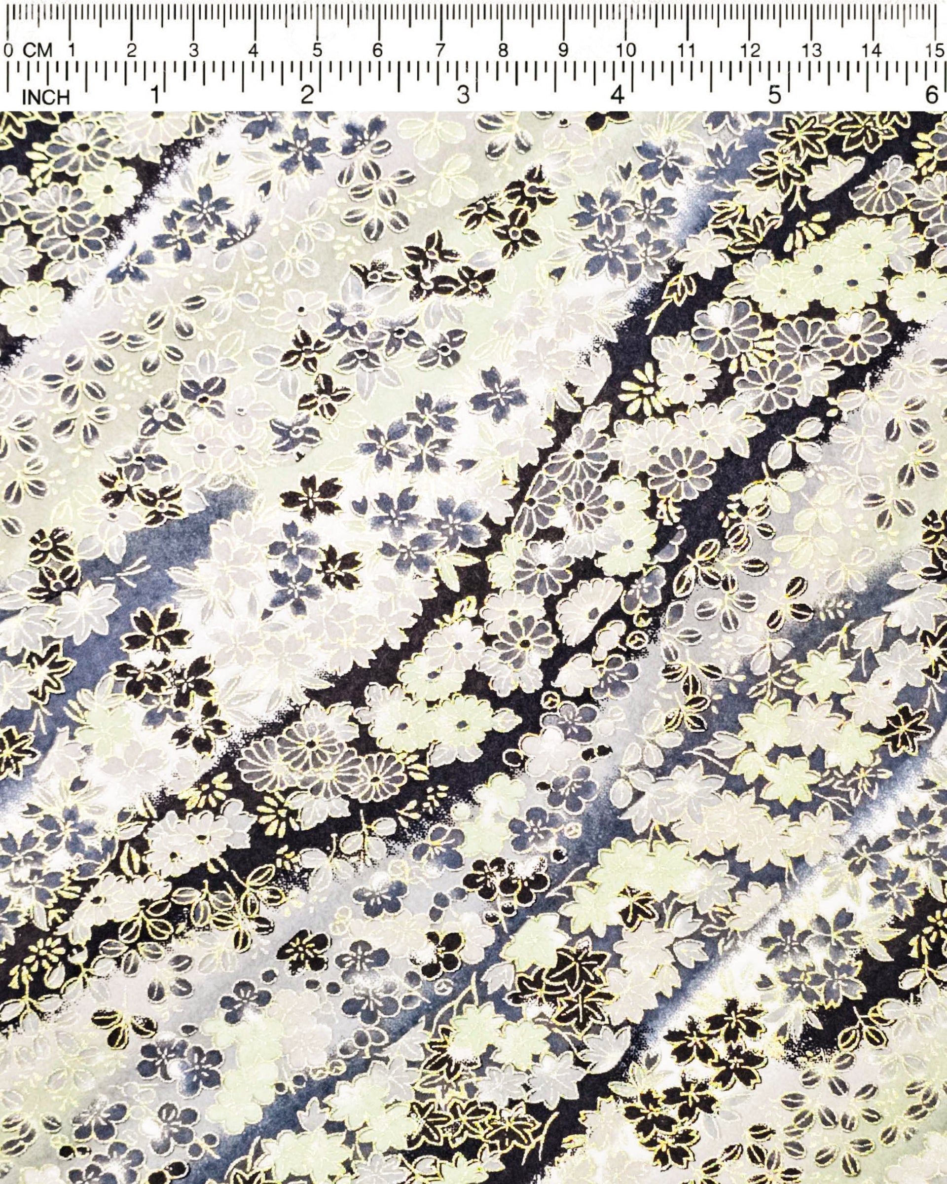 Japanese chiyogami paper featuring assorted gray and cream flowers on a gray and black background with metallic gold accents.