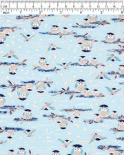 Japanese chiyogami paper featuring blue and gray owls perched on branches and flying around with a light blue night sky background adorned with small metallic gold stars and crescent moons.