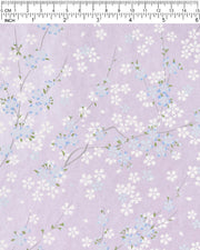 Japanese chiyogami paper featuring light blue and white cherry blossoms with green leaves and branches on a pearlescent light purple background.
