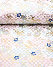 Japanese chiyogami paper featuring blue, pink, and metallic silver cherry blossoms on a blue and purple ichimatsu (checkered) background with metallic gold accents.