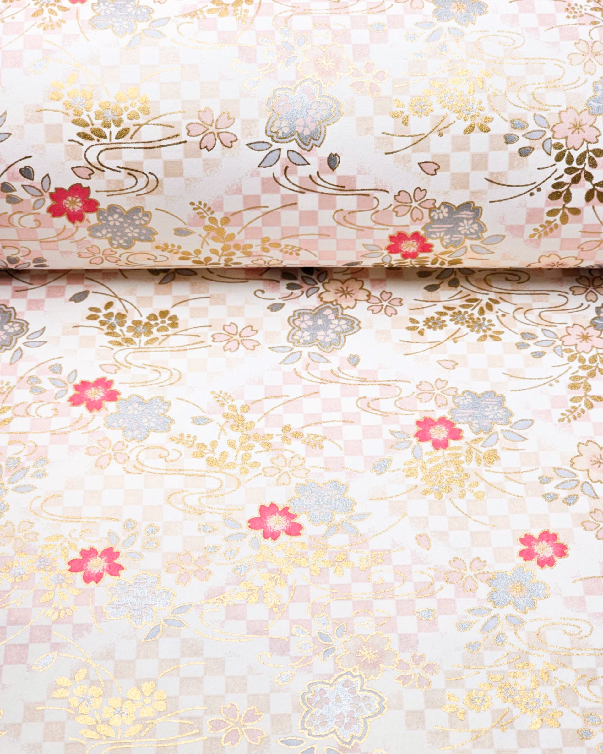 Japanese chiyogami paper featuring light pink, fuchsia, and metallic silver cherry blossoms on a pink and beige ichimatsu (checkered) background with metallic gold accents.